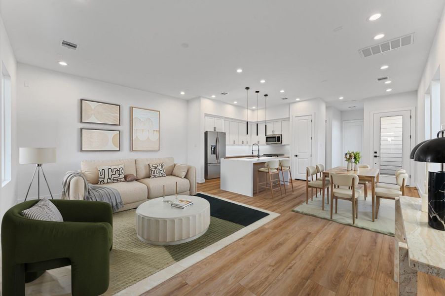 Photo has been virtually staged, a view from the living room into the open concept kitchen and dining area. Photo has been virtually staged, a view from the living room into the open concept kitchen and dining area.