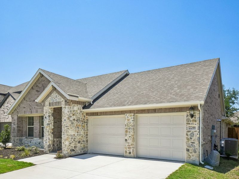 Front exterior of a new home in Stella Hills, Denton, TX, highlighting curb appeal (Image 23). Front exterior of a new home in Stella Hills, Denton, TX, highlighting curb appeal (Image 23).