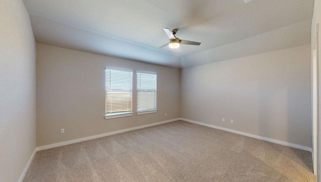 Unfurnished room featuring light carpet, a ceiling fan, and vaulted ceiling