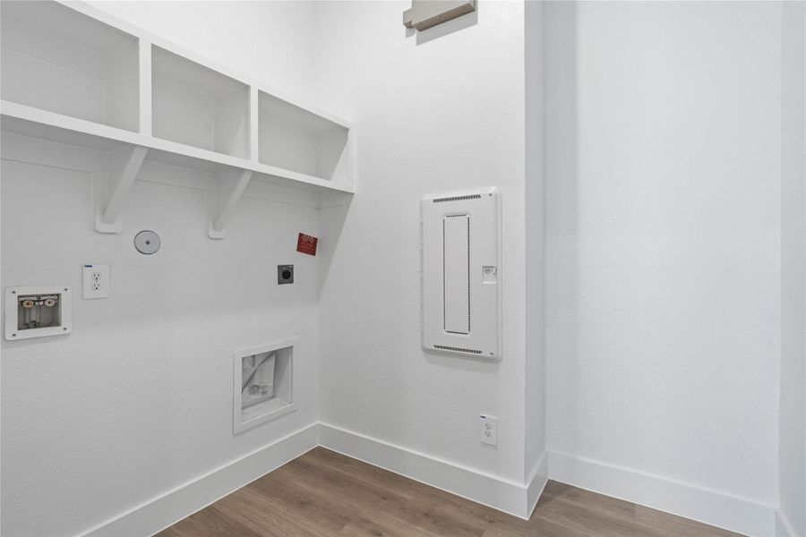Maximize organization and efficiency in this dedicated laundry room, a clean and bright space designed to handle all your home's needs.