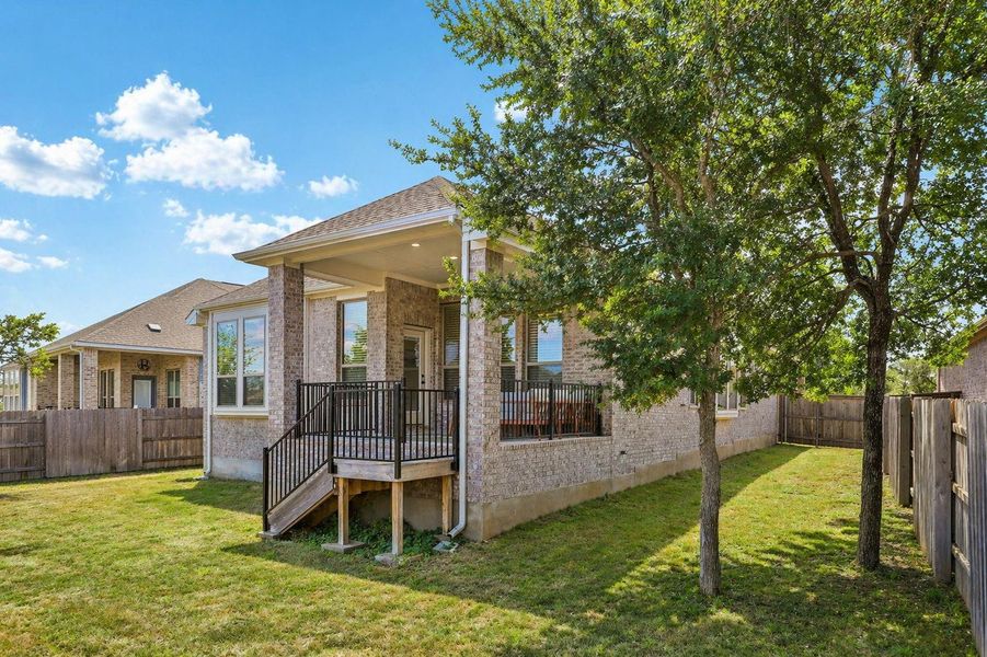 A private, fenced backyard offers a perfect outdoor retreat with a spacious covered patio.