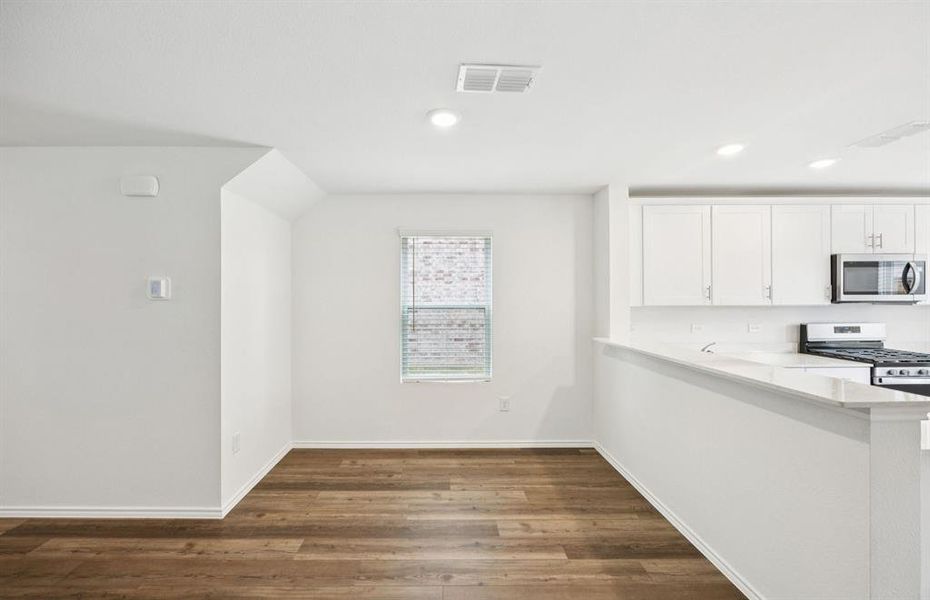 Dining nook off kitchen with large windows
