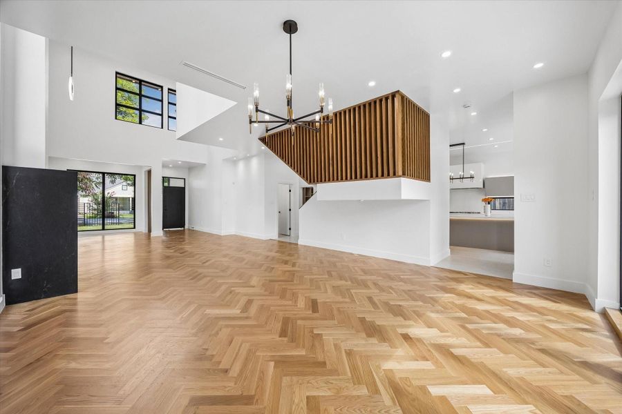 Floating staircase with warm wood slat detailing creates an architectural centerpiece. Floating staircase with warm wood slat detailing creates an architectural centerpiece.