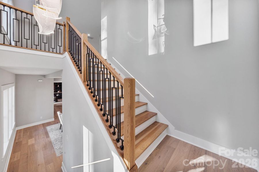Engineered hardwood floors throughout and custom stair railing