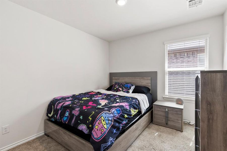 Bedroom featuring light colored carpet Bedroom featuring light colored carpet