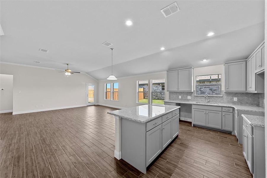 Kitchen with lofted ceiling, dark hardwood / wood-style floors, sink, gray cabinets, and ceiling fan