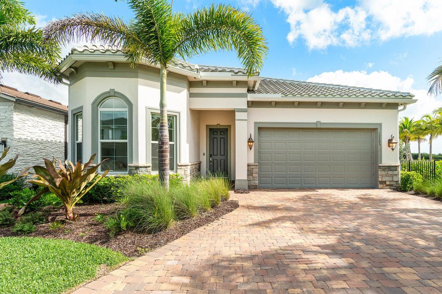 Front exterior of a new home in Avondale at Avenir, Palm Beach Gardens, FL, highlighting curb appeal (Image 1). Front exterior of a new home in Avondale at Avenir, Palm Beach Gardens, FL, highlighting curb appeal (Image 1).