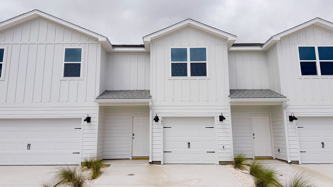 Front exterior of a new home in Salt Creek Townhomes at Mexico Beach, Mexico Beach, FL, highlighting curb appeal (Image 1). Front exterior of a new home in Salt Creek Townhomes at Mexico Beach, Mexico Beach, FL, highlighting curb appeal (Image 1).