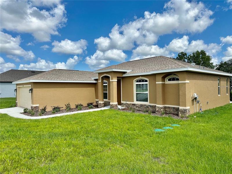 Front exterior of a new home in , Weeki Wachee, FL, highlighting curb appeal (Image 30).