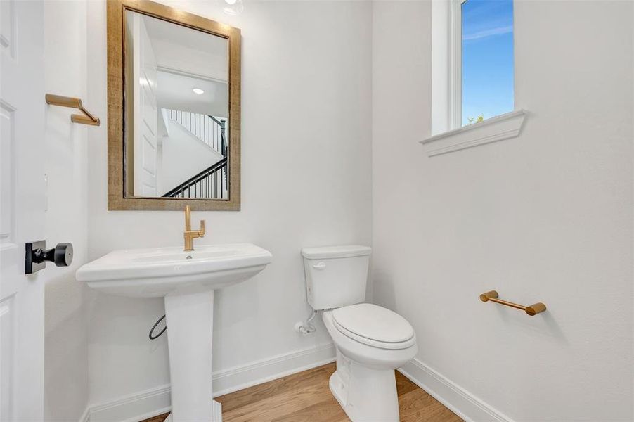 Pedestal sink with brass-finish faucet and hardware