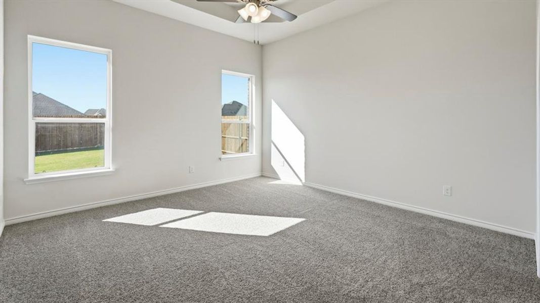 Empty room with carpet and ceiling fan Empty room with carpet and ceiling fan