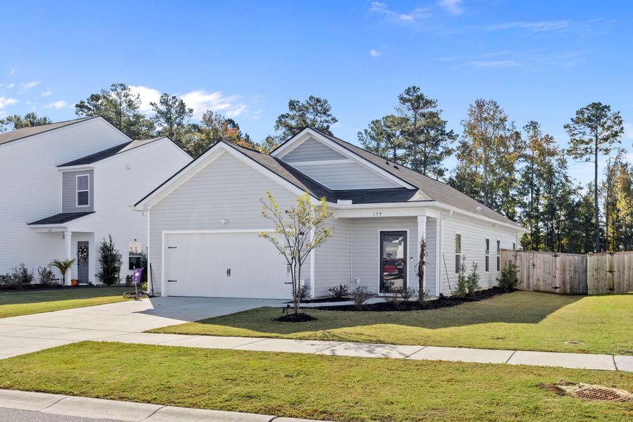 Front exterior of a new home in K. Hovnanian's® Four Seasons at Lakes of Cane Bay, Summerville, SC, highlighting curb appeal (Image 2). Front exterior of a new home in K. Hovnanian's® Four Seasons at Lakes of Cane Bay, Summerville, SC, highlighting curb appeal (Image 2).