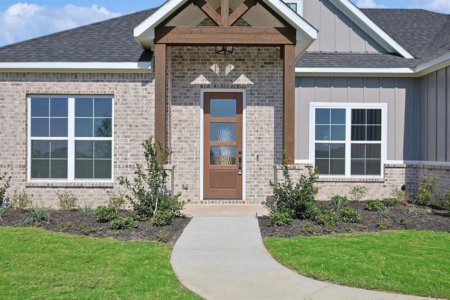 Entrance to property with a lawn