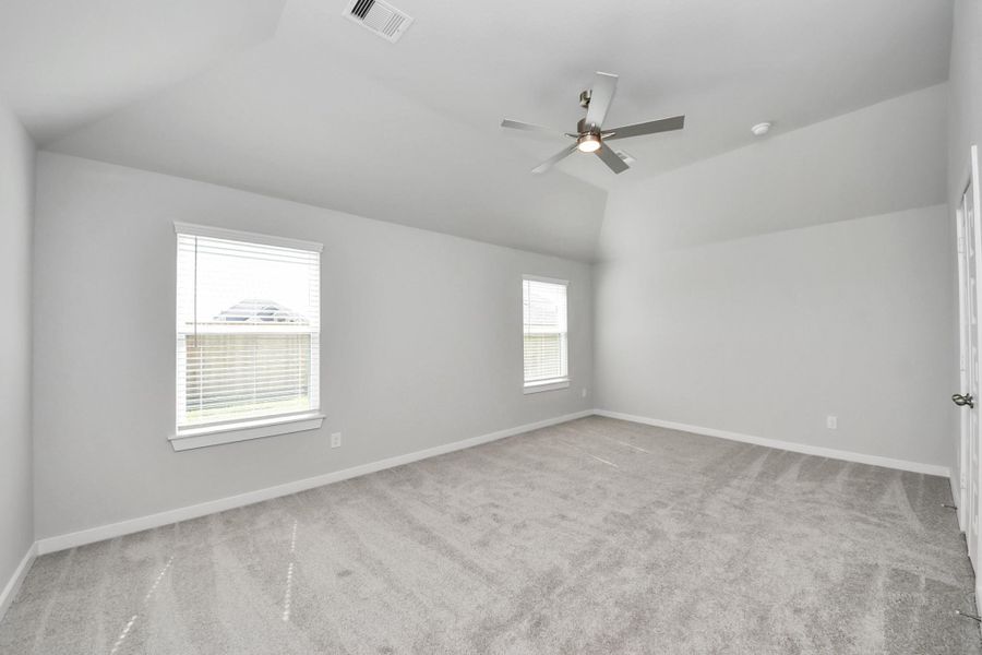 Come and unwind after a long day in this magnificent primary suite! This spacious room features plush carpet, warm paint, high ceilings and large windows with privacy blinds. Sample photo of completed home with similar floor plan. Actual colors and selections may vary. Come and unwind after a long day in this magnificent primary suite! This spacious room features plush carpet, warm paint, high ceilings and large windows with privacy blinds. Sample photo of completed home with similar floor plan. Actual colors and selections may vary.