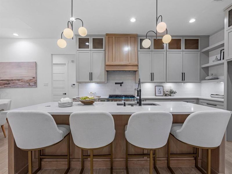 Seamless island, with pendant lighting, quartz counters, and a undermount sink