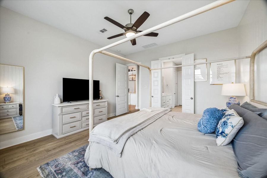 From this angle, the spacious primary bedroom showcases its thoughtful layout with easy access to the private en-suite bathroom.