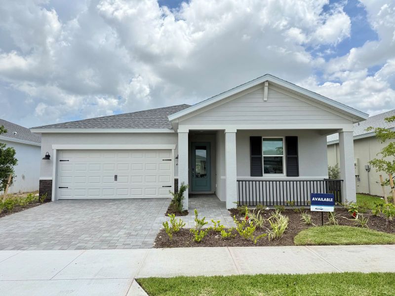 Front exterior of a new home in Crescent Lakes - Reserve Series, Punta Gorda, FL, highlighting curb appeal (Image 1). Front exterior of a new home in Crescent Lakes - Reserve Series, Punta Gorda, FL, highlighting curb appeal (Image 1).