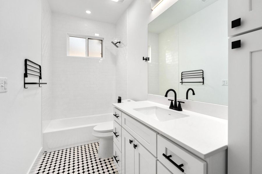 Bathroom with vanity and bathtub / shower combination