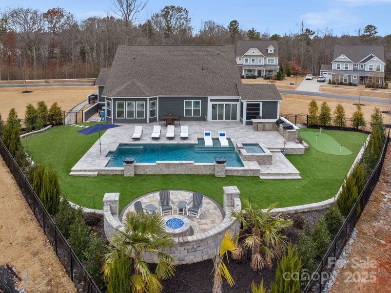 Fabulous outdoor oasis complete with pool, spa, kitchen, firepit & putting green