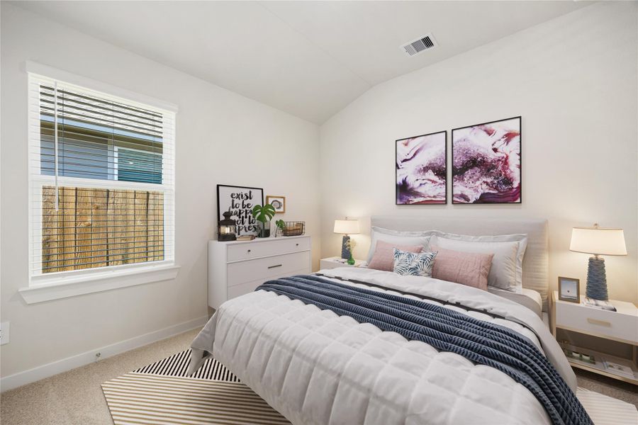 This inviting secondary bedroom offers soft natural light, neutral tones, and plush carpeting, creating a warm and comfortable space ideal for guests or family.