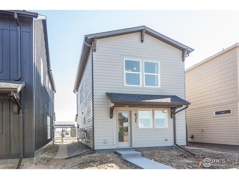 Front exterior of a new home in Prairie Song Cottages, Windsor, CO, highlighting curb appeal (Image 25).