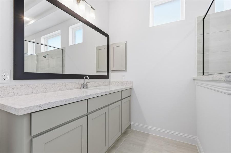 Bathroom featuring vanity and a walk in shower Bathroom featuring vanity and a walk in shower