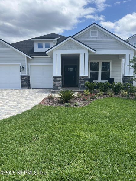 Front exterior of a new home in Middlebourne, St. Johns, FL, highlighting curb appeal (Image 1).