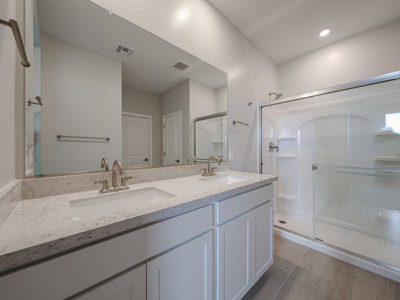 A bathroom with a large mirror.