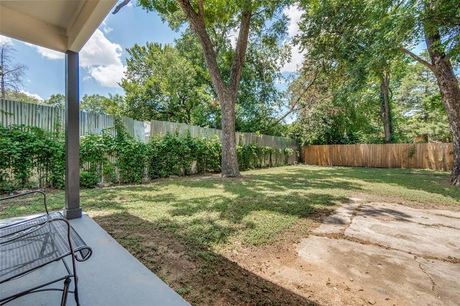 Expansive backyard featuring mature trees, a manicured lawn, and perimeter fencing Expansive backyard featuring mature trees, a manicured lawn, and perimeter fencing