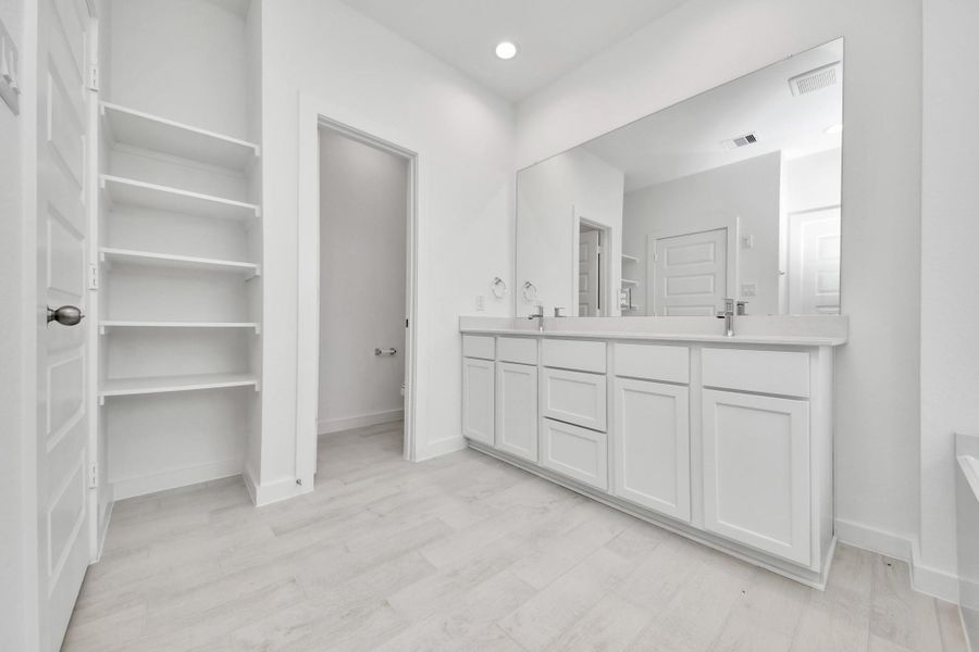 Elevate your daily routine at the elegant vanity, now equipped with double sinks, light countertops, modern hardware, and beautiful recessed lights. Elevate your daily routine at the elegant vanity, now equipped with double sinks, light countertops, modern hardware, and beautiful recessed lights.