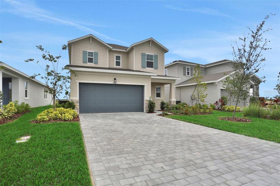 Front exterior of a new home in Turnleaf, Punta Gorda, FL, highlighting curb appeal (Image 21).