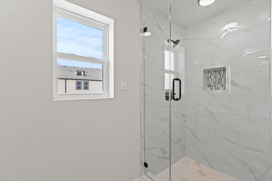 Bathroom featuring a marble finish shower