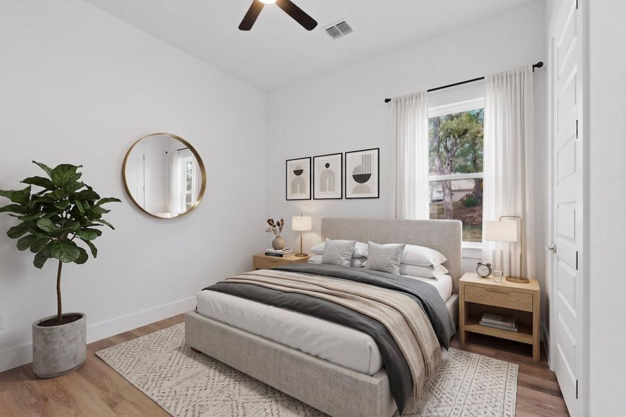 Natural light bathes this comfortable bedroom, featuring warm hardwood floors and a ceiling fan for year-round comfort.