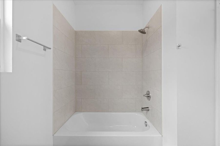 Private primary bathroom featuring granite countertop vanity, modern fixtures, and clean, bright finishes.