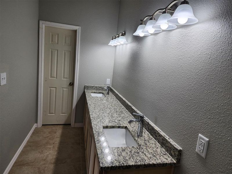 Bathroom featuring tile patterned flooring and vanity