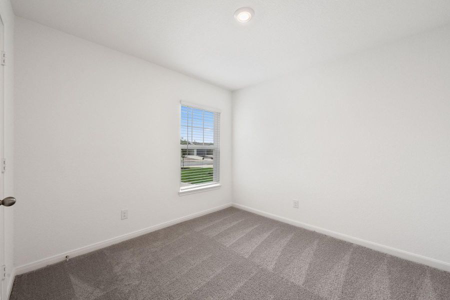 A well-lit bedroom offering a serene and spacious retreat.