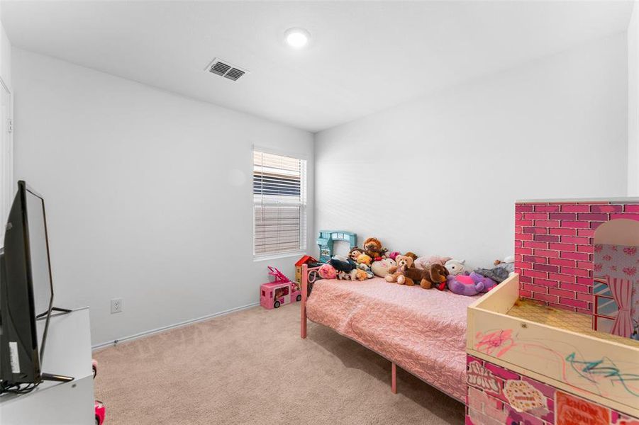 Bedroom featuring light colored carpet and baseboards Bedroom featuring light colored carpet and baseboards