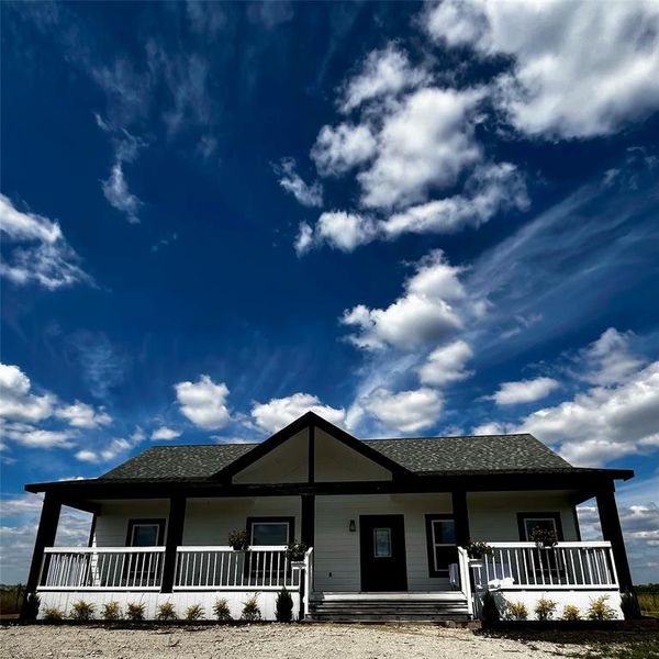 Ranch-style home featuring covered porch and roof with shingles. Ranch-style home featuring covered porch and roof with shingles.