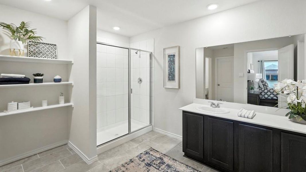 Full bathroom with a shower stall, vanity, and ensuite bath Full bathroom with a shower stall, vanity, and ensuite bath