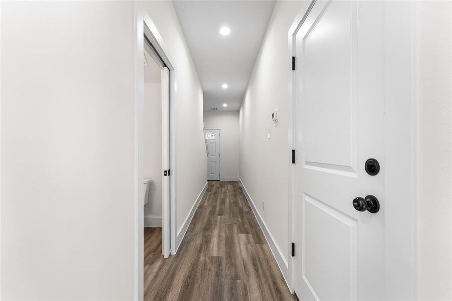 Corridor featuring recessed lighting and dark wood-style floors Corridor featuring recessed lighting and dark wood-style floors