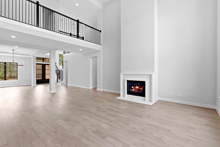 Living room with view of upstairs landing overlooking living room.