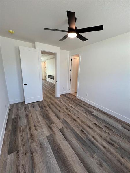 bedroom 1 with a ceiling fan and dark wood finished floors