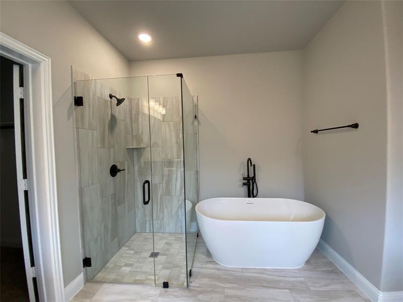 Modern freestanding tub and framless glass walk-in shower with dropped tile pan Modern freestanding tub and framless glass walk-in shower with dropped tile pan