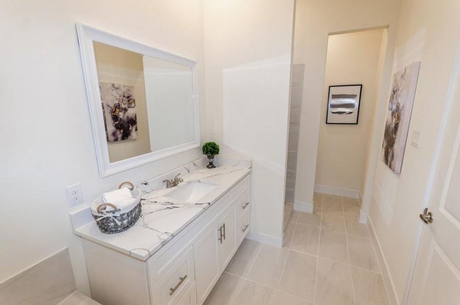 Bathroom featuring vanity and tile patterned floors