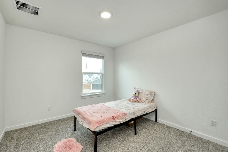 Bedroom featuring carpet, visible vents, and baseboards