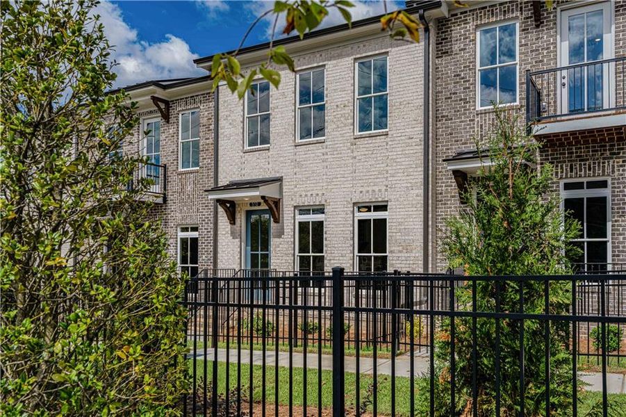 Exterior details and patio area of a home in Ward's Crossing Townhomes, Johns Creek (Image 28).
