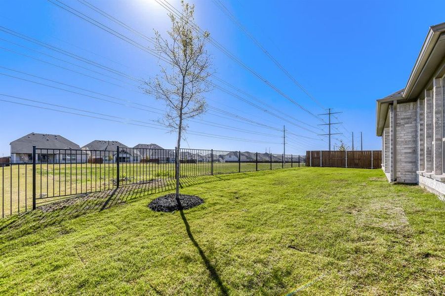 Fenced backyard featuring a residential view