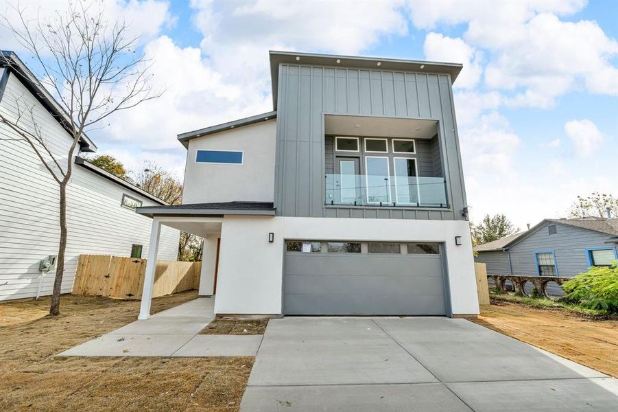 Contemporary home featuring a balcony and a garage