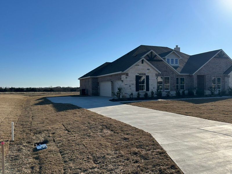 Front exterior of a new home in Fannin Ranch, Leonard, TX, highlighting curb appeal (Image 2). Front exterior of a new home in Fannin Ranch, Leonard, TX, highlighting curb appeal (Image 2).