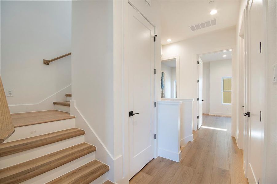 Stairway with wood finished floors and recessed lighting Stairway with wood finished floors and recessed lighting